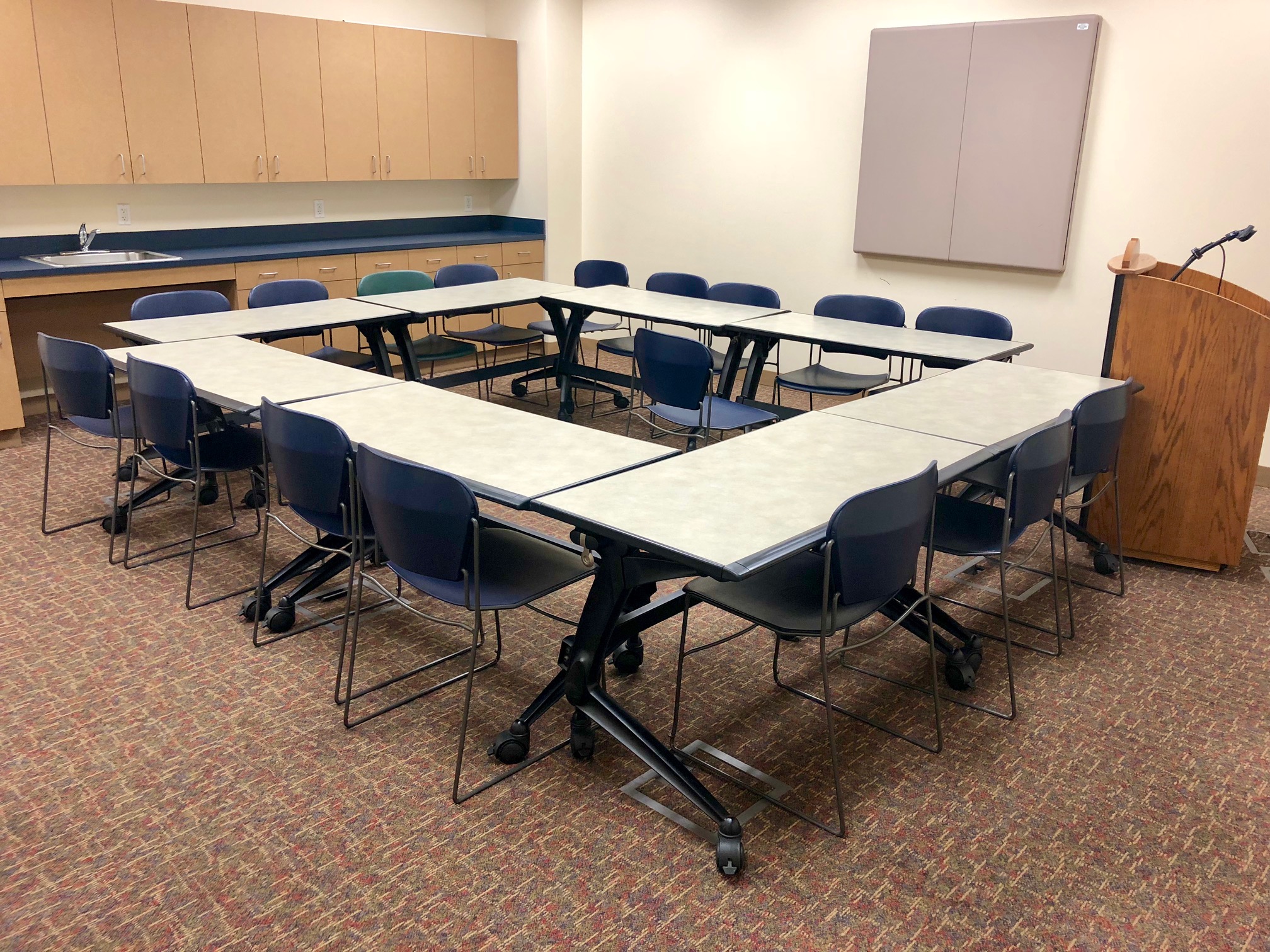 Photo of the conference classroom with tables placed in an enclosed square