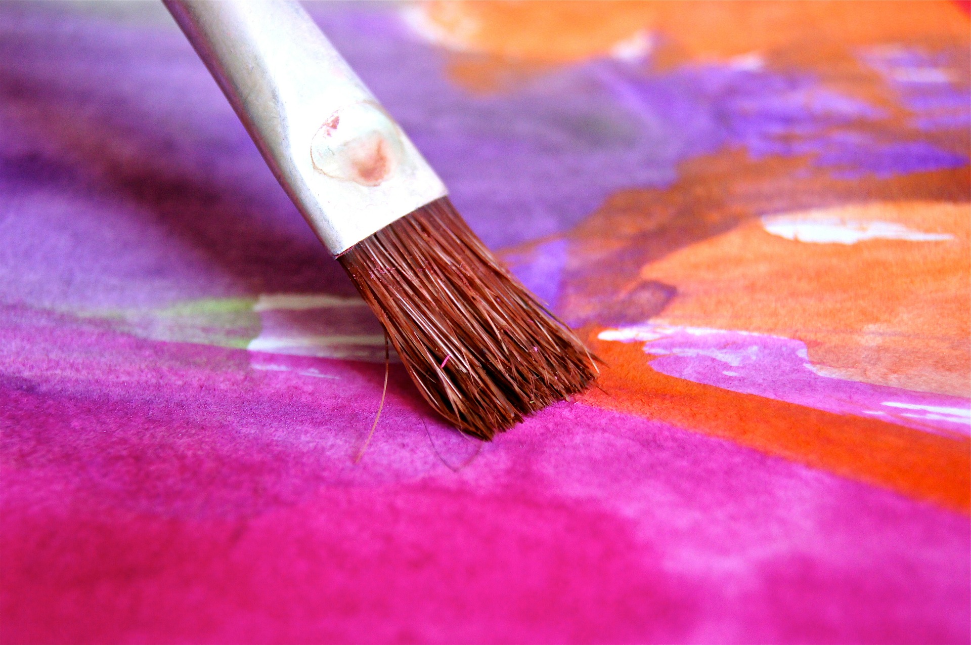 paintbrush on colorful canvas