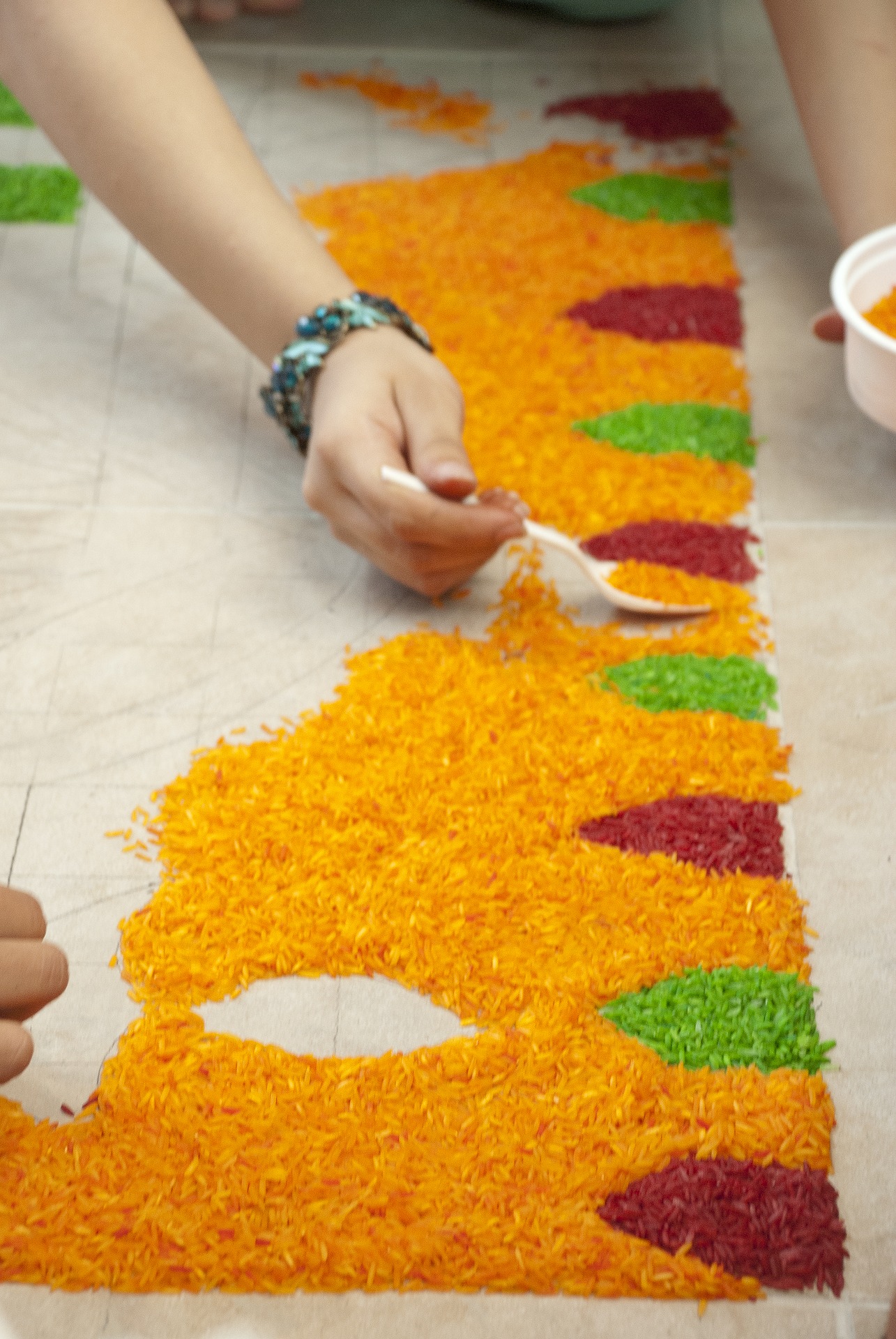 colorful rice in a pattern, rangoli art