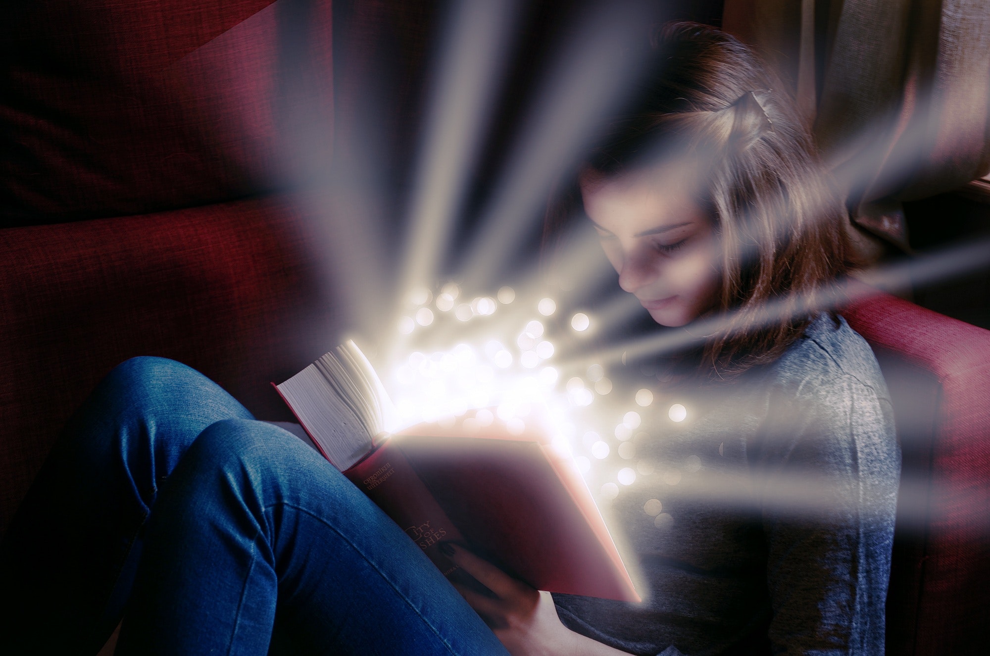 teen girl reading glowing book