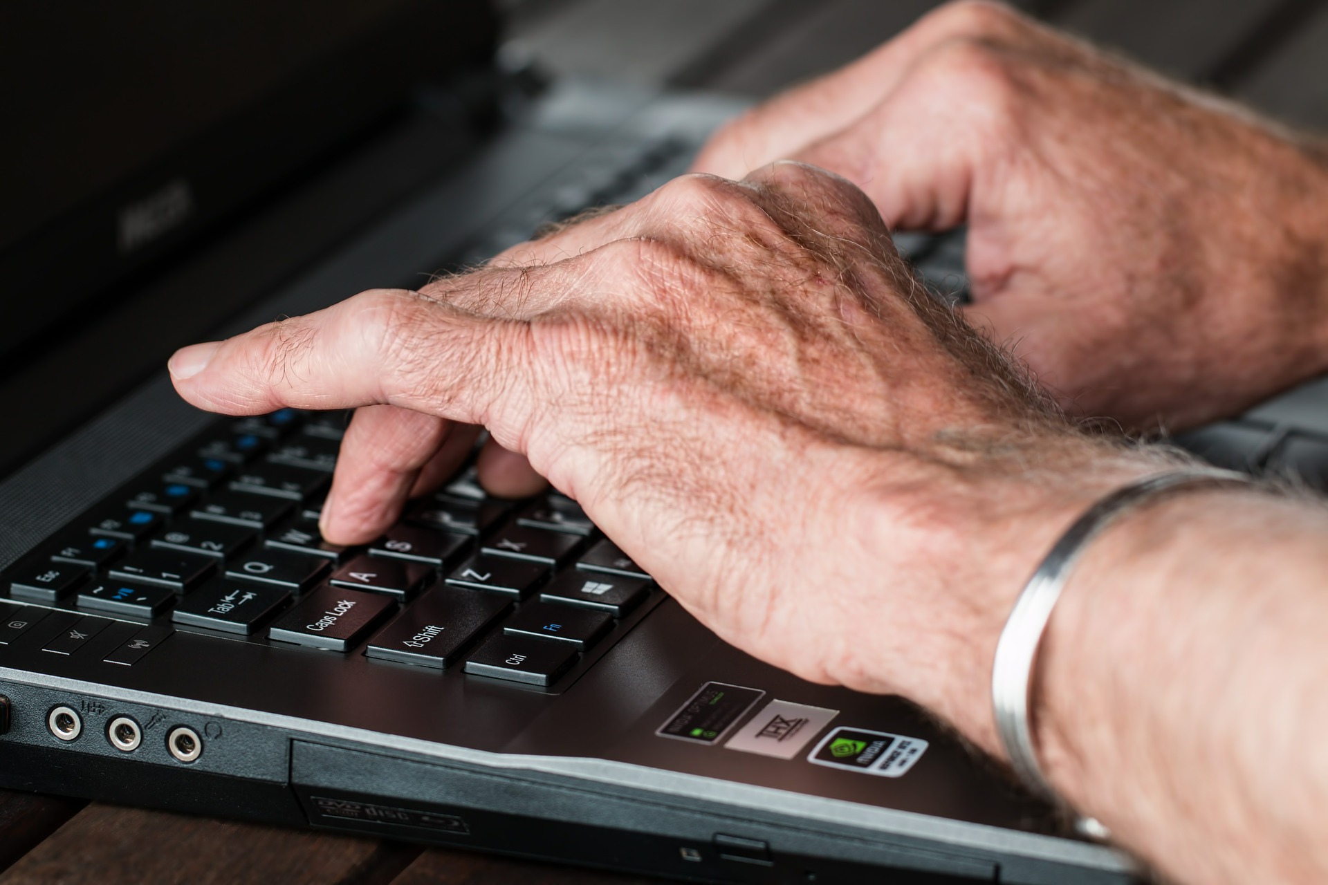 adult typing on computer