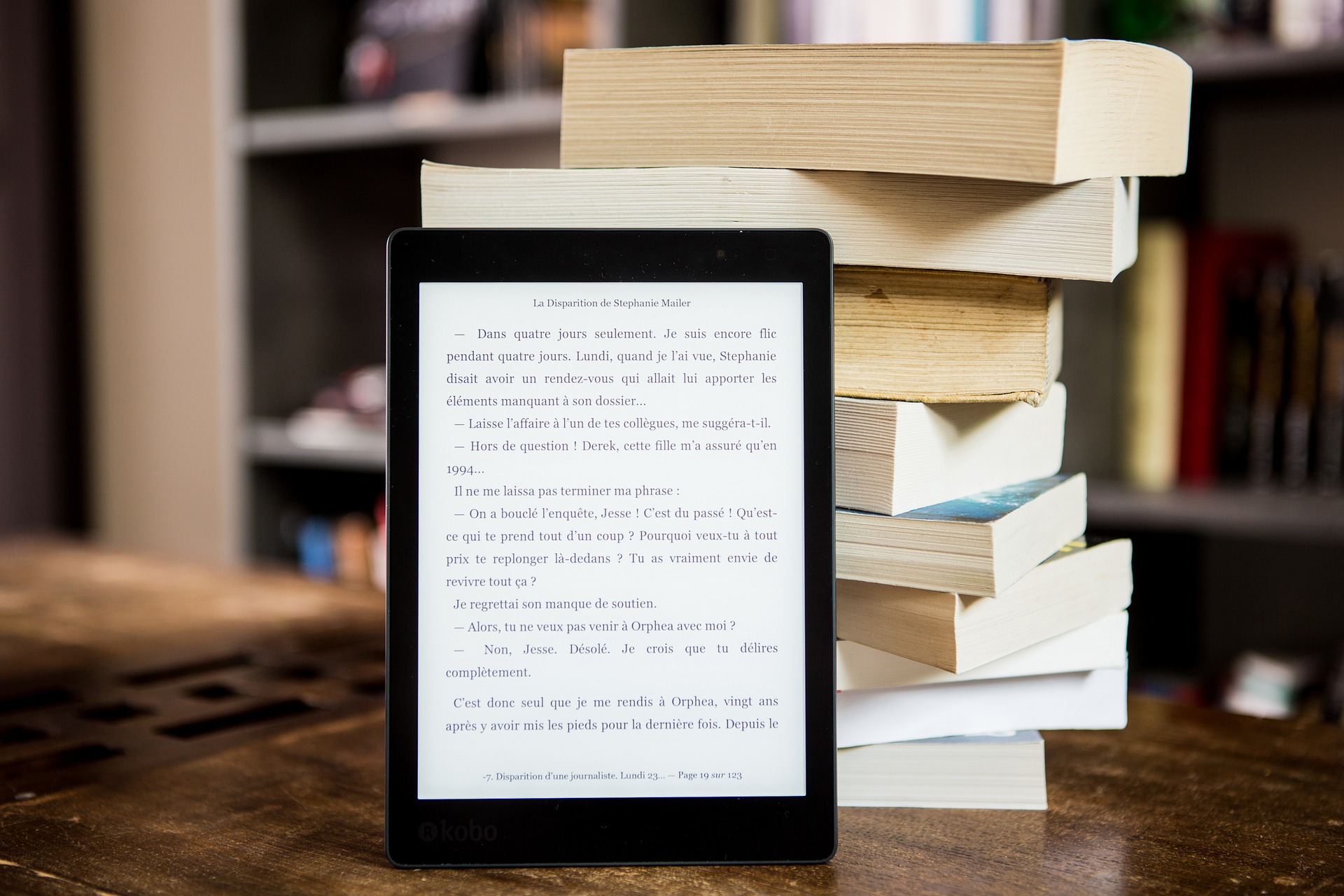 ebook reader with a stack of books