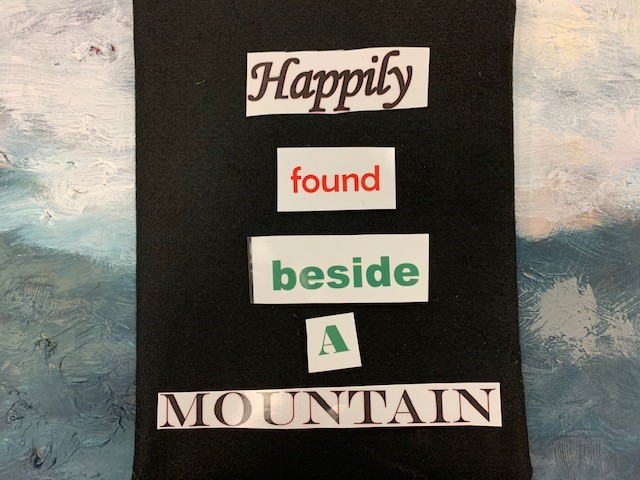 poem that reads happily found beside a mountain