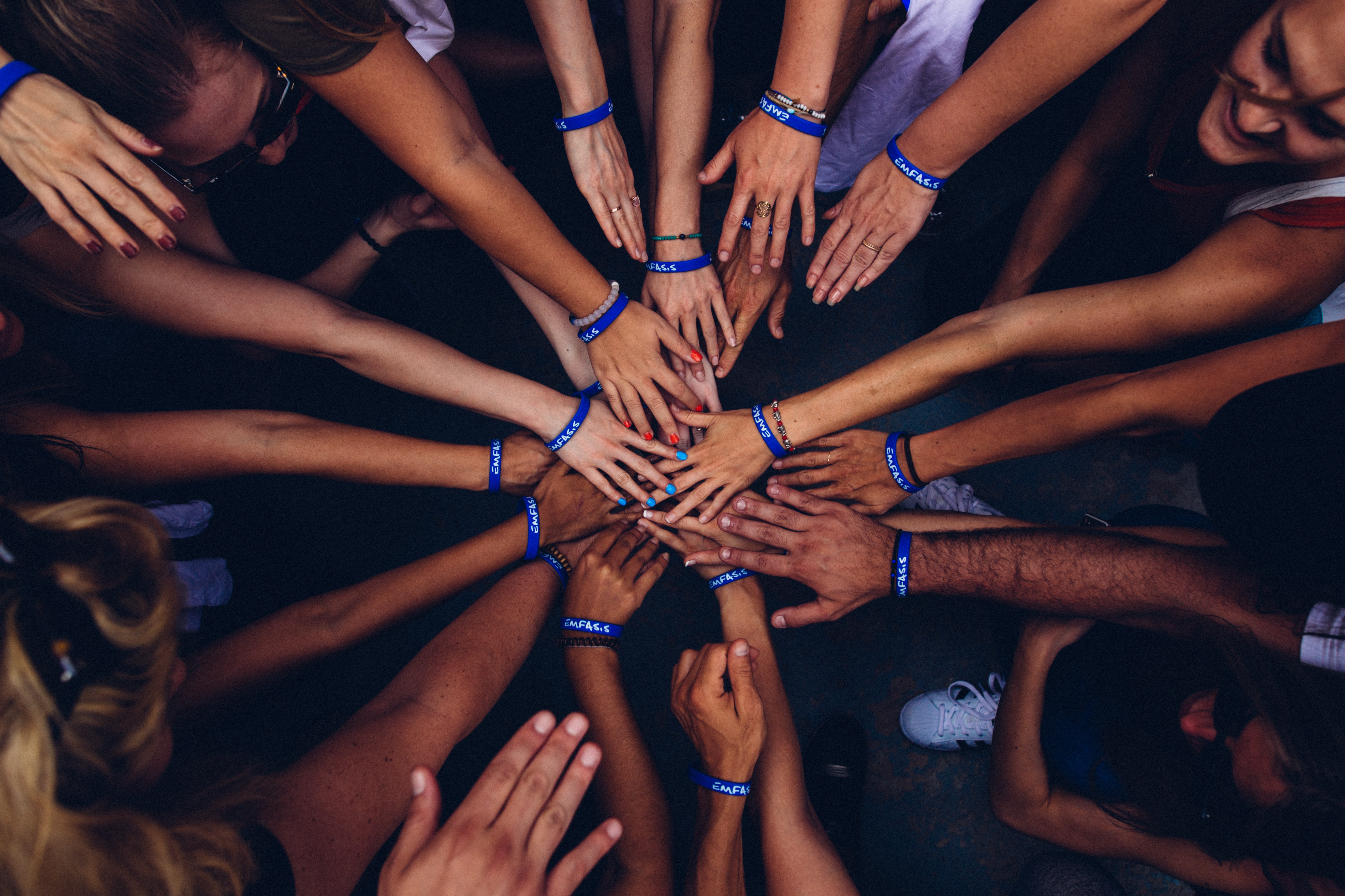 Group putting their hands in a circle