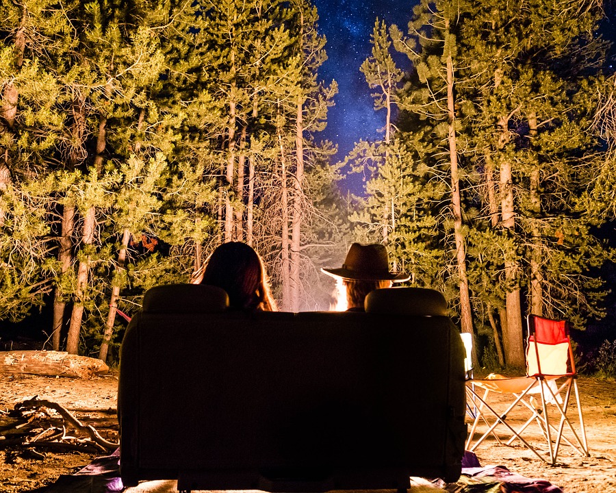 couple outside in front of a fire