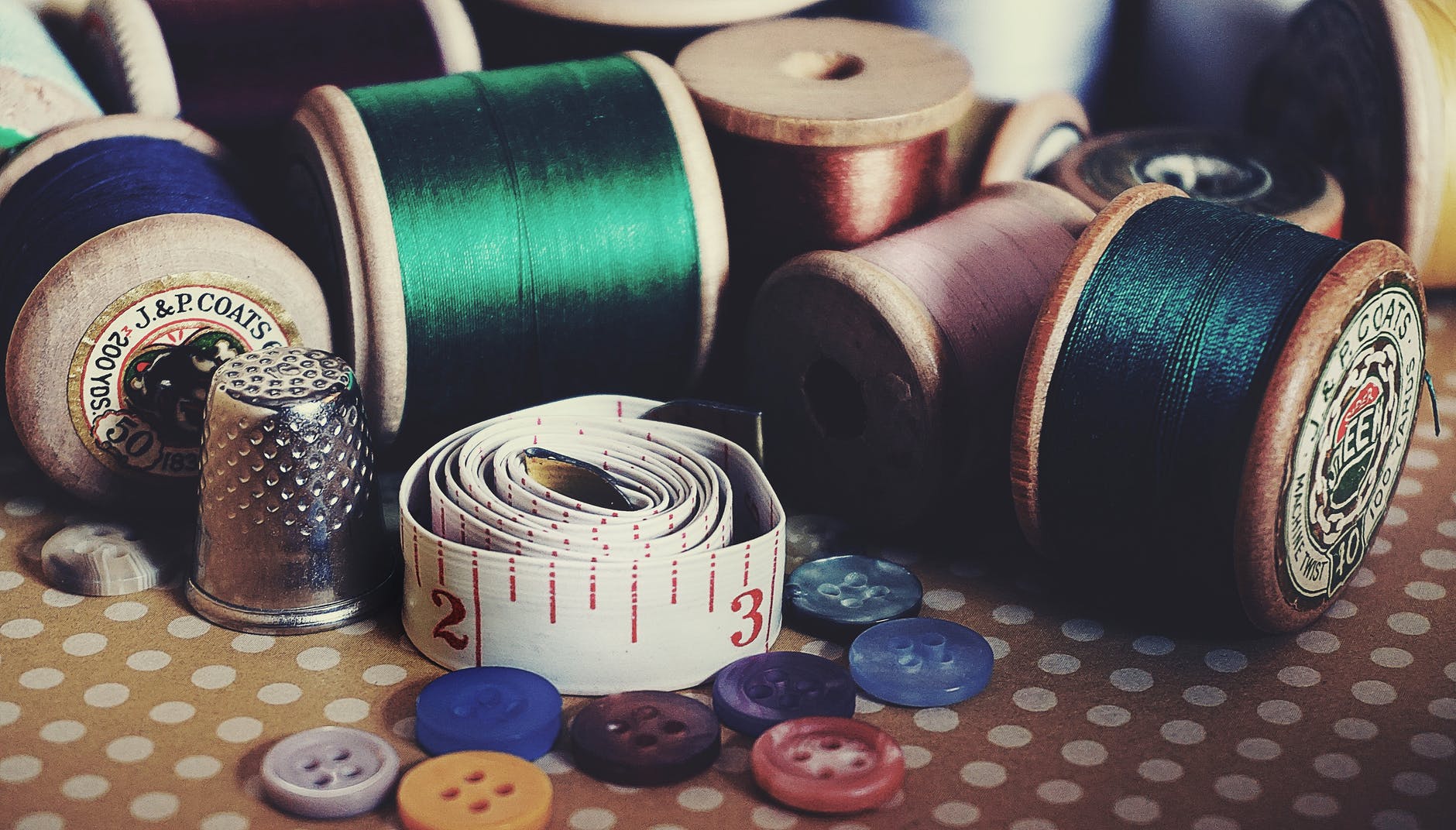 Assorted buttons, thread, and tape measure