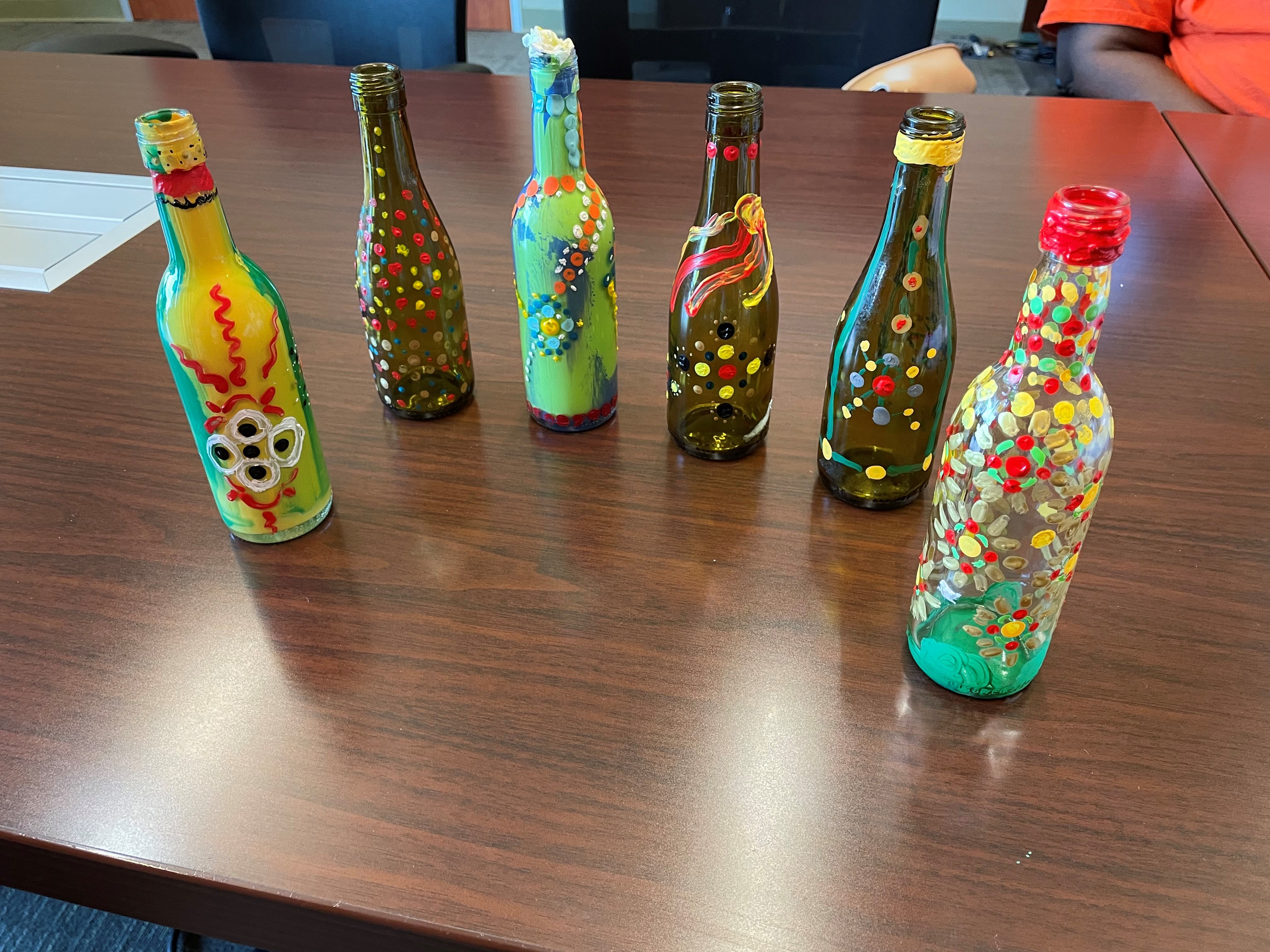 image of dot mandala painting on glass bottles