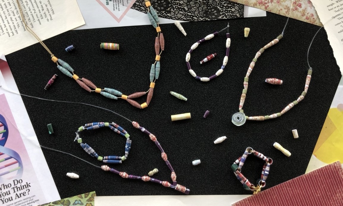 an array of examples of paper bead jewelry, displayed on a black background.