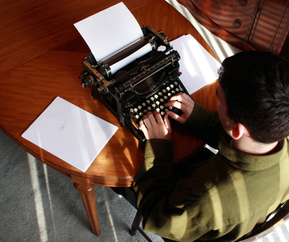 A person writing a novel on a typewriter.