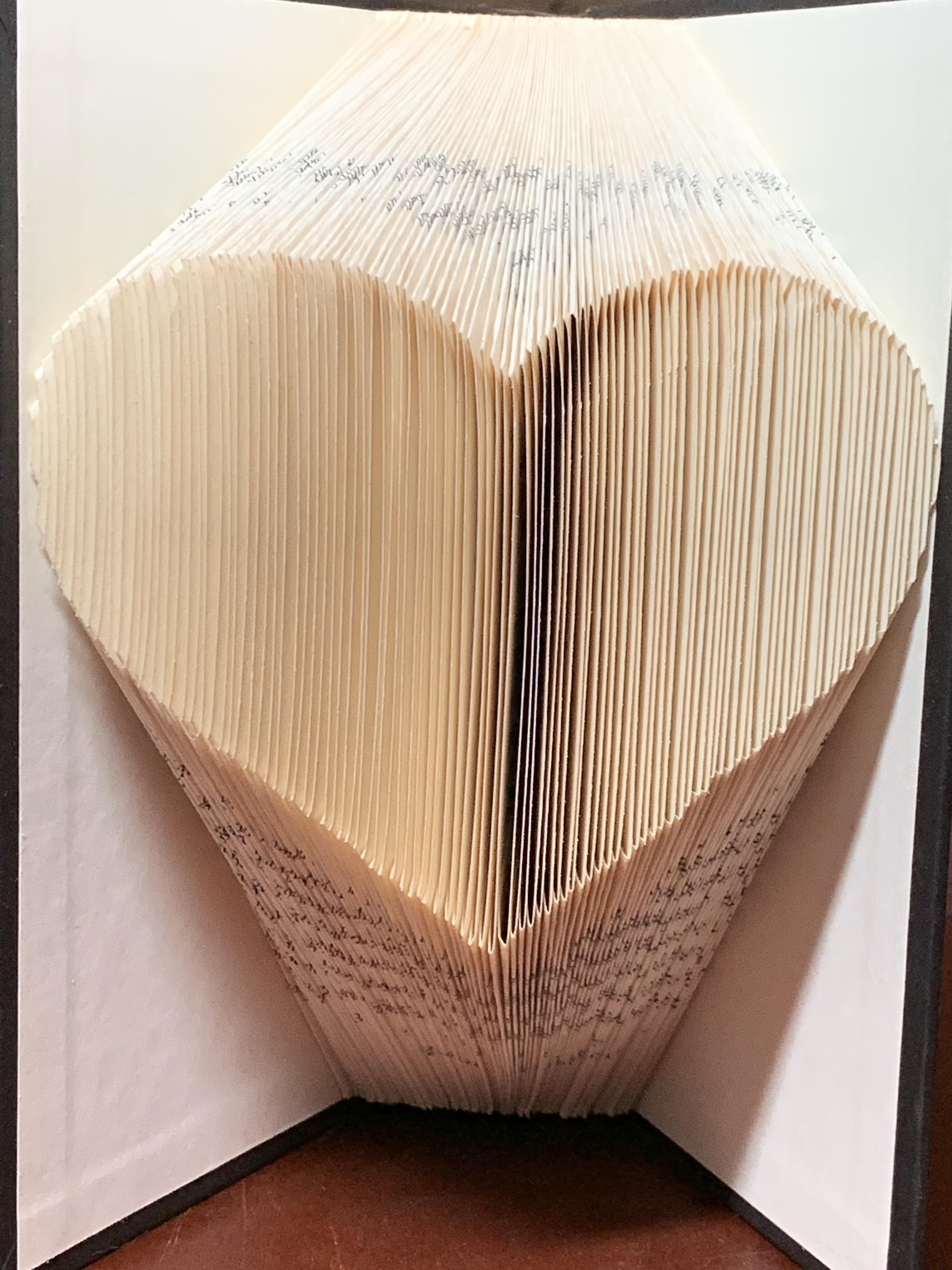 An example of the craft - a book with pages folded to create a heart shape