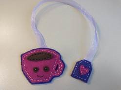 A cup-shaped bookmark made of stitched felt