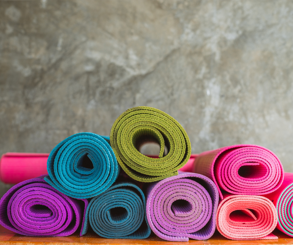 An assortment of colorful, rolled yoga mats