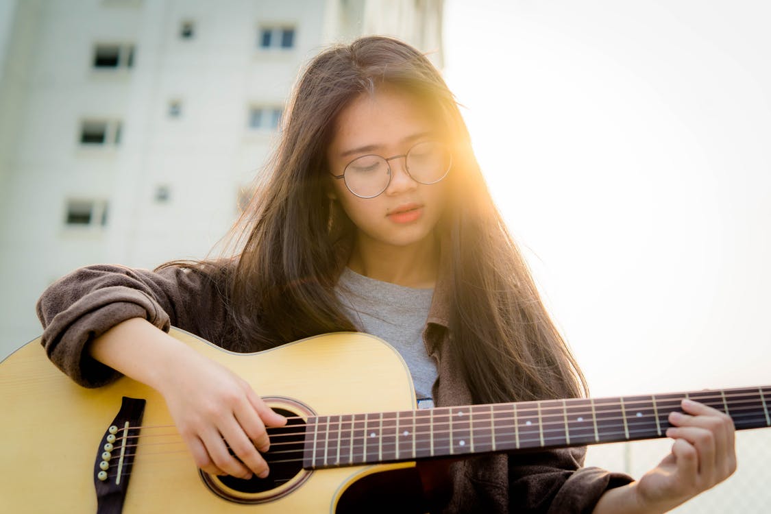 Teen girl playing guitar