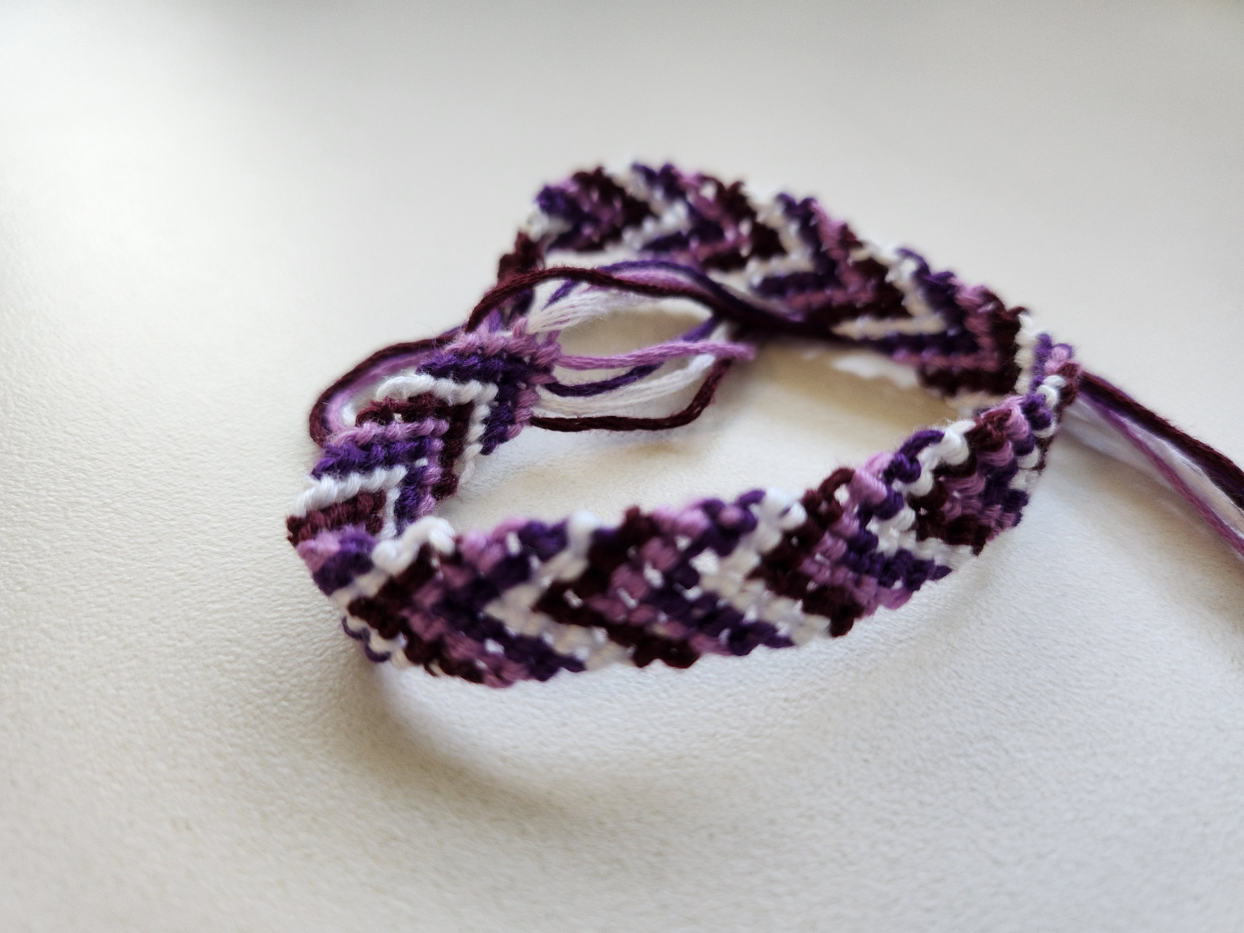 close up of a friendship bracelet in a chevron pattern using the colors 