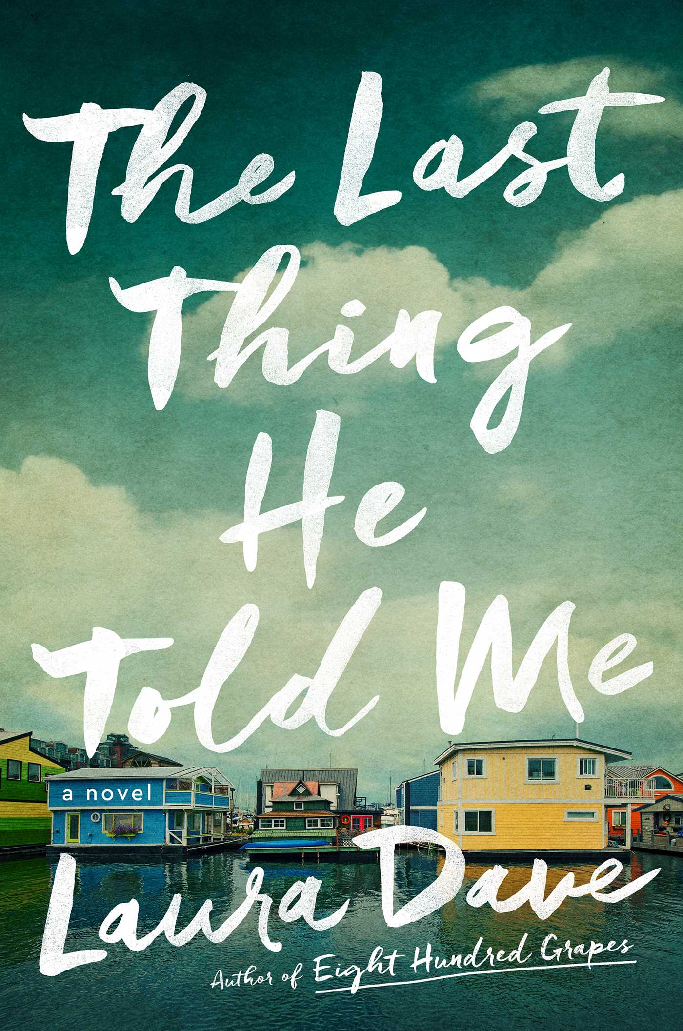Book cover of "The Last Thing He Told Me" by Laura Dave; featuring a row of color houses by a body of water
