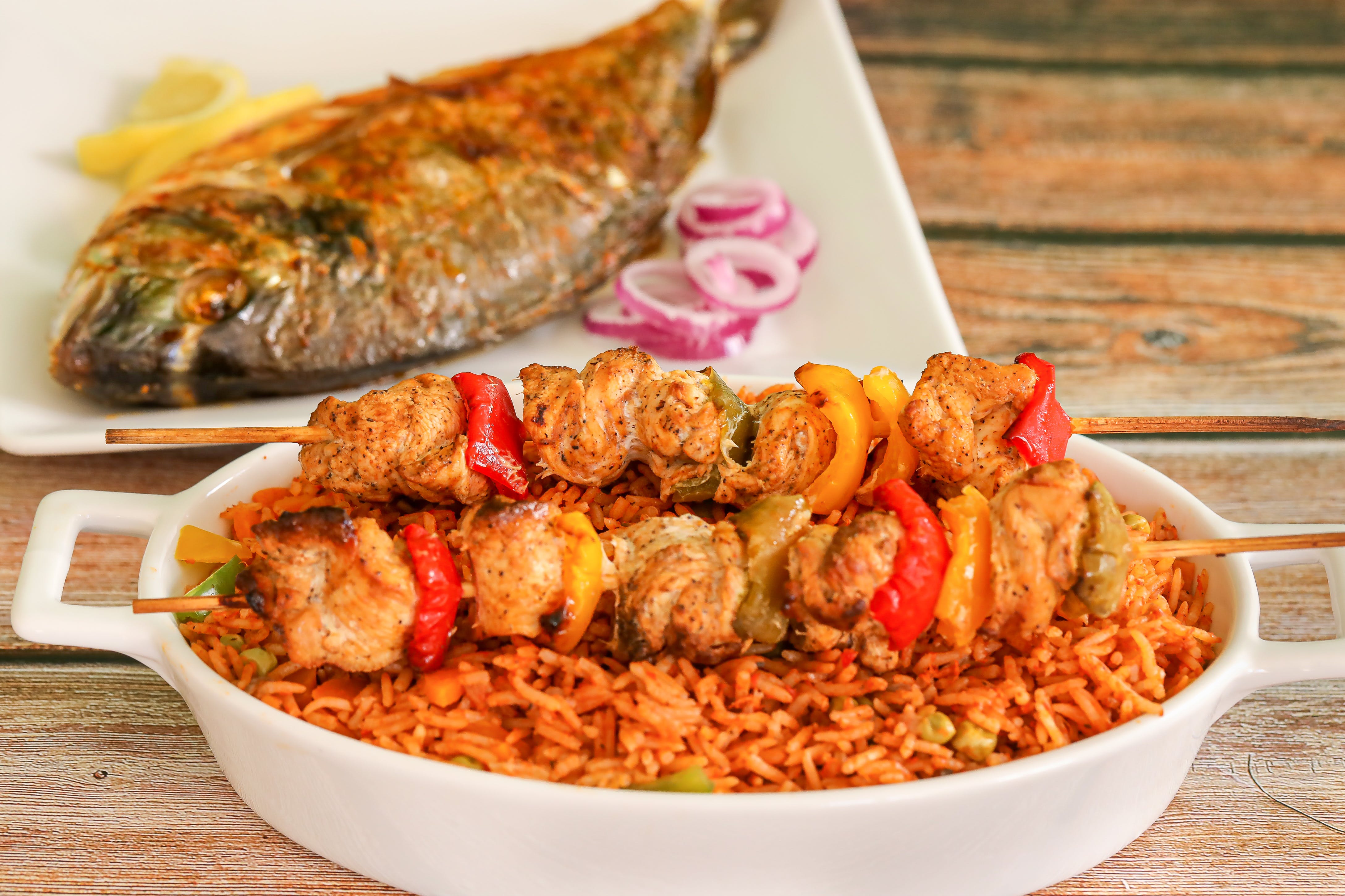 Jollof rice and grilled chicken skewers