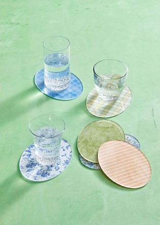 an image of colorful egg shaped coasters with glasses half filled with water on them