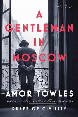 Book cover of A Gentleman in Moscow. A man in a suit and hat is looking over a balcony. 