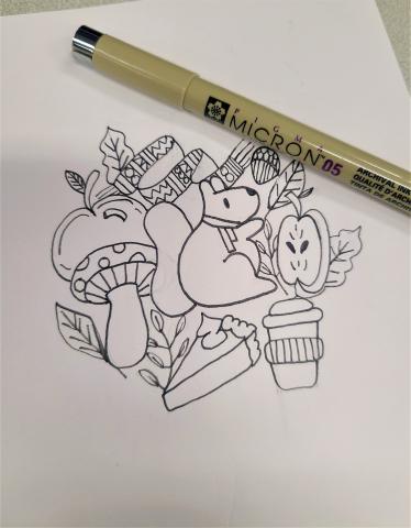 Pen and sketches of fall-themed items like a squirrel, pie, and coffee in black ink on white paper