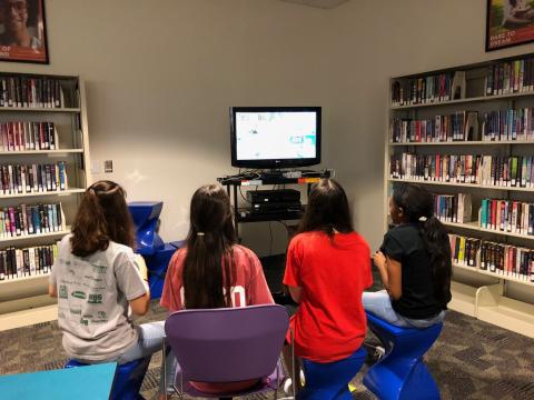 image of teens playing video games in the library