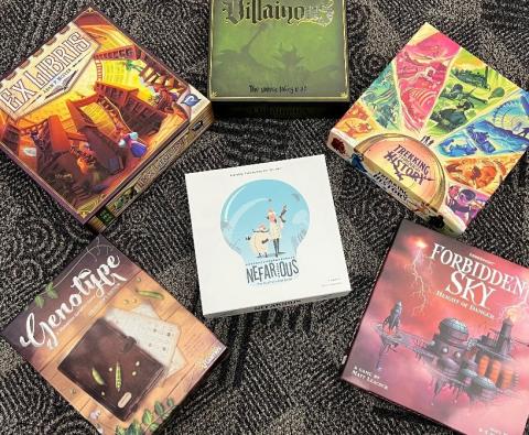 photo of six board game boxes on the floor