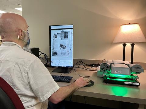 Daniel Sample demonstrates the ScanPro 3000 microfilm scanner in the Genealogy and Local History Department at George Memorial Library in Richmond. 
