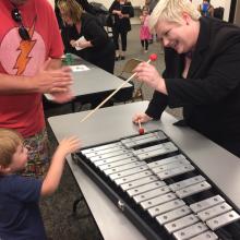 FBSO Director shows instruments to child during "petting zoo."