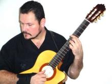 John Acevedo holding a guitar