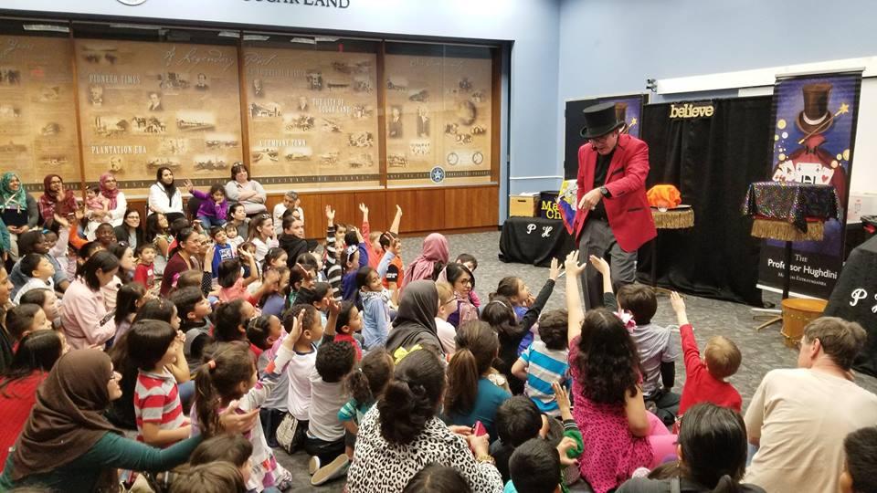 Magician pointing to a child in the audience during magic show